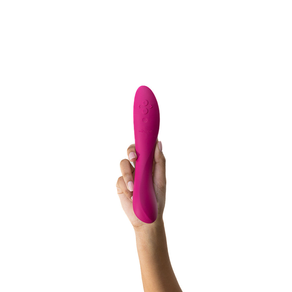 a brown manicured hand holds the we-vibe rave vibrator showing off the ridges and angles