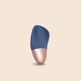 gold and slate blue sex toy with wing-like sides and a round center where it creates it's tapping sensation