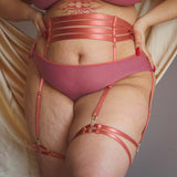 plus size model wearing the Hearts of Venus Bikini in Copper Rose as well as the matching waist cincher and leg garters