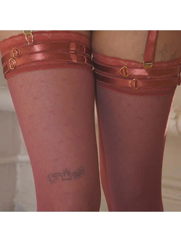 close up of the matching stocking and strappy leg garters on a model,