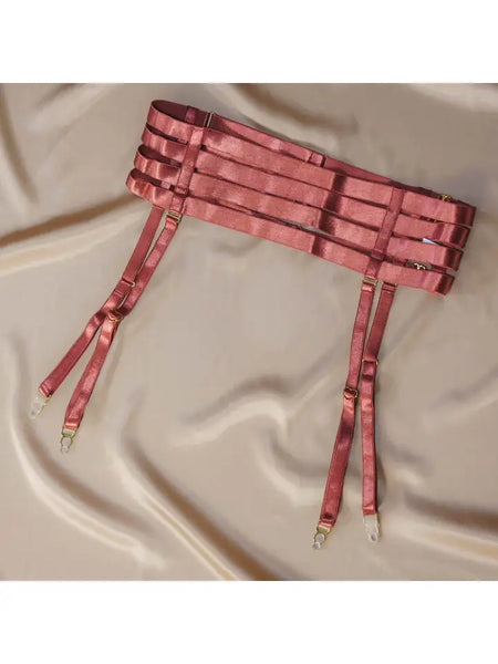 flat lay image of the Hearts of Venus Strappy Waist Cinching Garter in Copper Rose on a cream fabric background