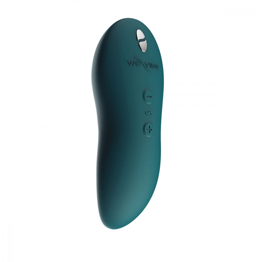 an oblong teal green vibrator showing the three buttons, the magnetic charging points, and the we-vibe brand logo in silicone