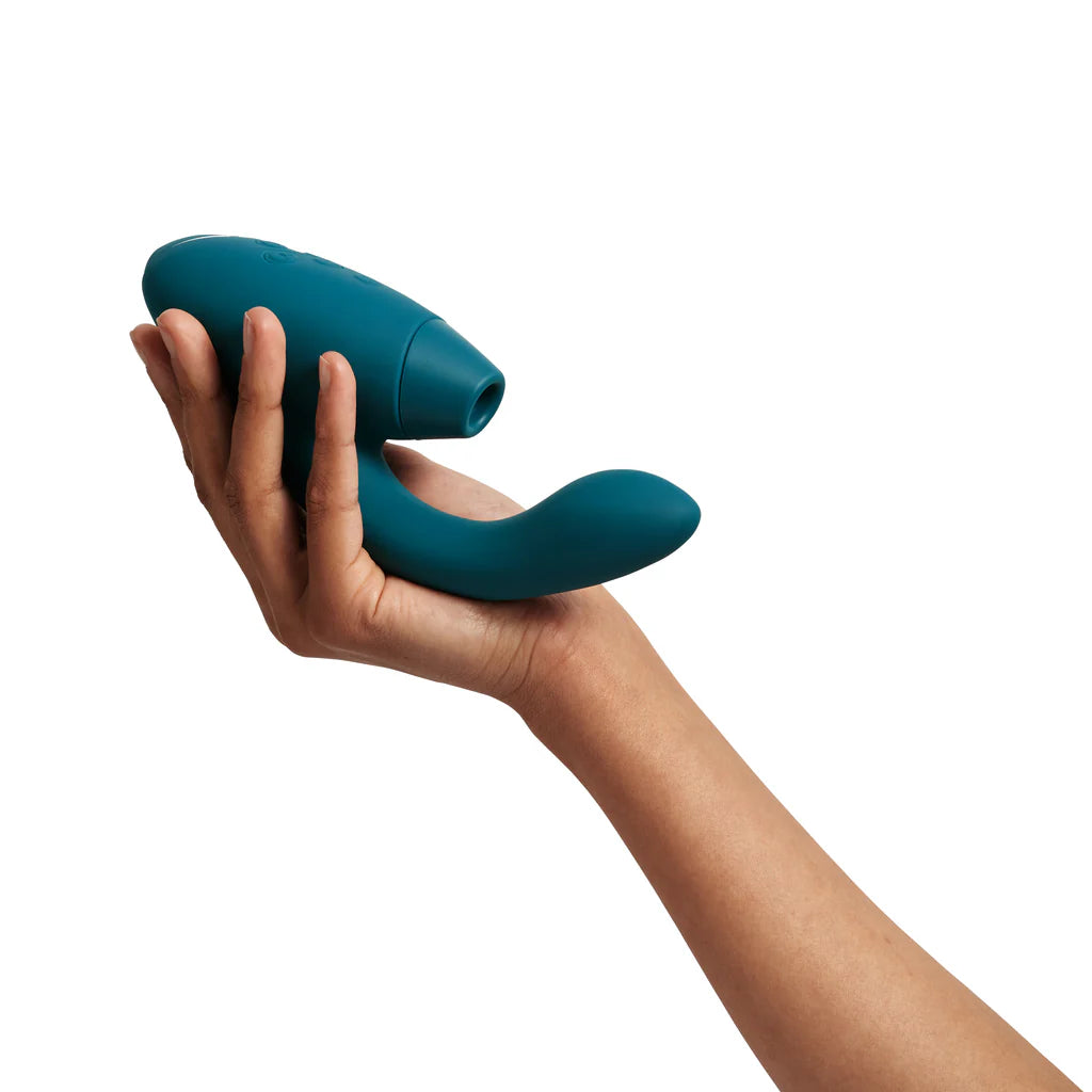 white hand shows the size of the womanizer duo 2 rabbit sex toy that takes up the whole palm and extends several inches past it with the vibrating arm. it is a large toy