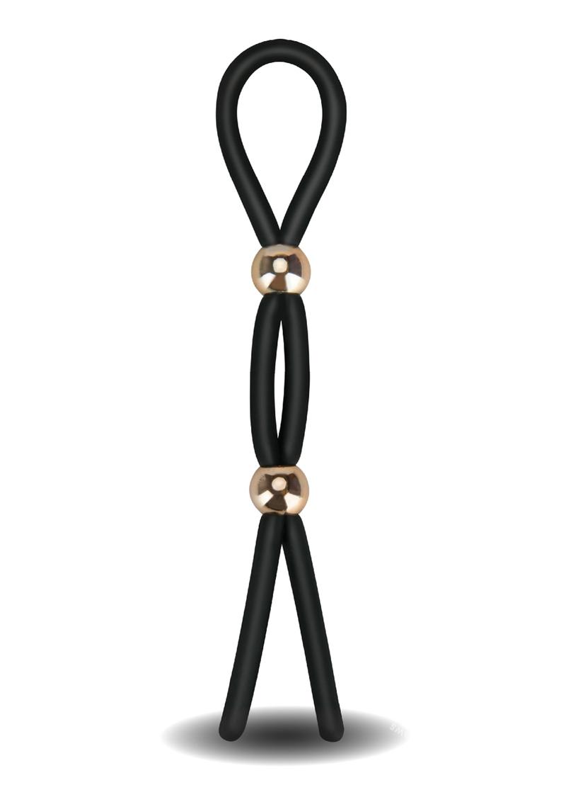 a black silicone band stands looped at the top, with two gold plastic beads each sitting 1/3 of the way down the length of the loop.  This is a body-safe adjustable c-ring that can serve as a double cock ring too.