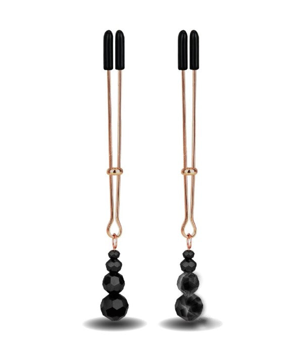 Gold tweezer style nipple clamps, often called vice clamps, with three black beads at the bottom. the nipple clamps have black rubber tips